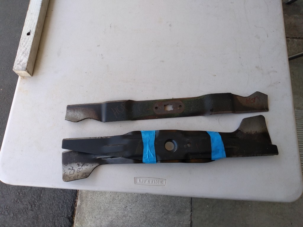a pair of lawn mower blades ready for sharpening
